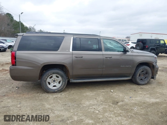 2015 Chevrolet Suburban LT z VIN 1GNSCJKC6FR675585, wystawiony jako IAAI lot #41510570 z przebiegiem 156 818 mil mil oraz . Historia ofert i sprzedaży dostępna na DreamBid. Obrazek 12.