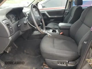2002 Jeep Grand Cherokee Laredo with VIN 1J4GW48S02C174656, listed as a Copart auction lot 56954155 with 235,427 mi miles and Salvage title. Bid and sale history available at DreamBid. Image 7.