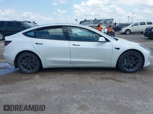 2023 Tesla Model 3 with VIN 5YJ3E1EA5PF407054, listed as a IAAI auction lot 42313770 with 57,621 mi miles and . Bid and sale history available at DreamBid. Image 13.