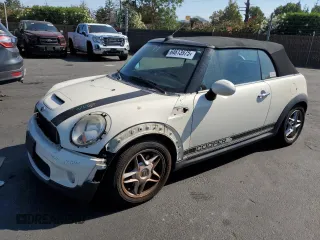 2009 MINI Convertible S with VIN WMWMS33509TY08040, listed as a Copart auction lot 64613975 with 124,938 mi miles and Salvage title. Bid and sale history available at DreamBid. Image 1.