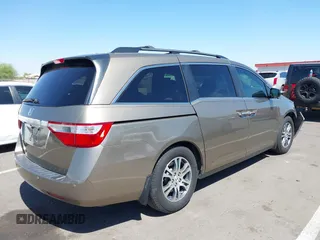 2012 Honda Odyssey EX-L z VIN 5FNRL5H63CB033049, wystawiony jako IAAI lot #42260501 z przebiegiem 165 693 mil mil oraz . Historia ofert i sprzedaży dostępna na DreamBid. Obrazek 4.