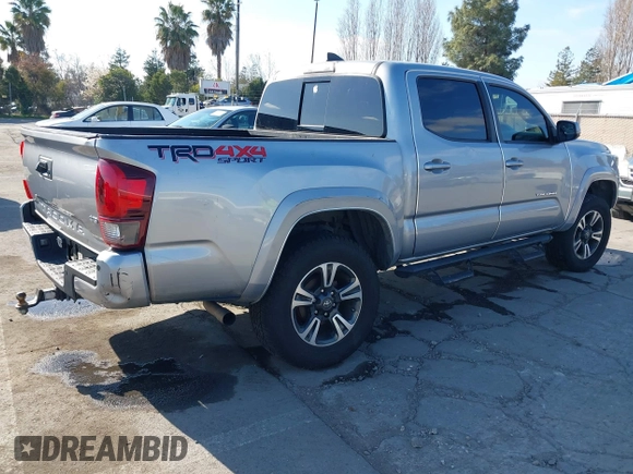 2018 Toyota Tacoma SR with VIN 3TMCZ5AN6JM185891, listed as a IAAI auction lot 41450665 with 53,749 mi miles and . Bid and sale history available at DreamBid. Image 4.