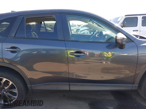 2016 Mazda CX-5 Grand Touring z VIN JM3KE2DYXG0649781, wystawiony jako IAAI lot #41636329 z przebiegiem 83 433 mil mil oraz . Historia ofert i sprzedaży dostępna na DreamBid. Obrazek 13.