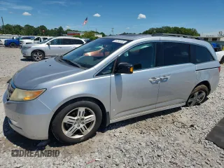 2011 Honda Odyssey Touring with VIN 5FNRL5H90BB012992, listed as a Copart auction lot 64762405 with 115,689 mi miles and Salvage title. Bid and sale history available at DreamBid. Image 1.