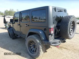 2015 Jeep Wrangler Unlimited Willys Wheeler with VIN 1C4BJWDG9FL750049, listed as a IAAI auction lot 42136188 with 115,328 mi miles and . Bid and sale history available at DreamBid. Image 3.