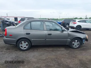 2002 Hyundai Accent GL z VIN KMHCG45C52U372587, wystawiony jako IAAI lot #42244428 z przebiegiem 43 538 mil mil oraz . Historia ofert i sprzedaży dostępna na DreamBid. Obrazek 13.