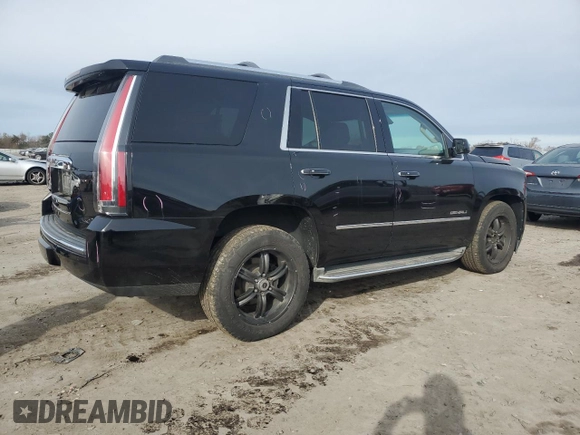 2015 GMC Yukon Denali with VIN 1GKS1CKJ1FR303049, listed as a Copart auction lot 82435514 with 100,693 mi miles and Salvage Title. Bid and sale history available at carsss.com. Image 3.