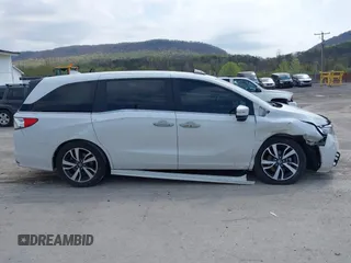 2021 Honda Odyssey Touring with VIN 5FNRL6H80MB010952, listed as a IAAI auction lot 42080412 with 90,594 mi miles and . Bid and sale history available at DreamBid. Image 13.