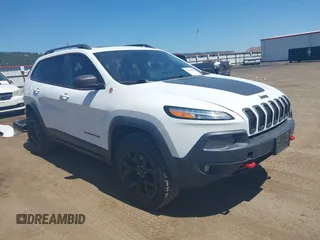 2014 Jeep Cherokee Trailhawk with VIN 1C4PJMBSXEW236807, listed as a IAAI auction lot 42660980 with 157,225 mi miles and . Bid and sale history available at DreamBid. Image 1.