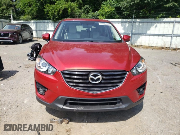 2016 Mazda CX-5 Grand Touring z VIN JM3KE2DY0G0722334, wystawiony jako Copart lot #59998185 z przebiegiem 51 449 mil mil oraz Szkoda całkowita • Salvage title. Historia ofert i sprzedaży dostępna na DreamBid. Obrazek 5.