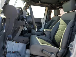 2010 Jeep Wrangler Sport with VIN 1J4AA2D16AL144842, listed as a Copart auction lot 50173535 with 106,000 mi miles and Salvage Title. Bid and sale history available at carsss.com. Image 7.
