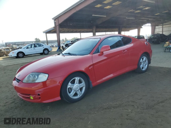 2003 Hyundai Tiburon GT z VIN KMHHN65F63U060104, wystawiony jako Copart lot #84560184 z przebiegiem 160 120 mil mil oraz Czysty tytuł • Clean title. Historia ofert i sprzedaży dostępna na DreamBid. Obrazek 1.