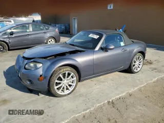2006 Mazda MX-5 Miata Sport z VIN JM1NC25F260115830, wystawiony jako Copart lot #76844774 z przebiegiem 52 599 mil mil oraz Szkoda całkowita • Salvage title. Historia ofert i sprzedaży dostępna na DreamBid. Obrazek 1.