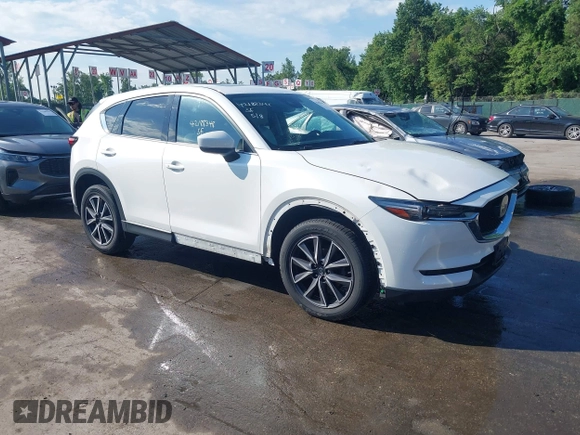 2018 Mazda CX-5 Grand Touring z VIN JM3KFBDM8J0420422, wystawiony jako IAAI lot #42188348 z przebiegiem 102 216 mil mil oraz . Historia ofert i sprzedaży dostępna na DreamBid. Obrazek 1.