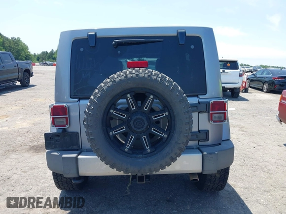 2013 Jeep Wrangler Unlimited Sahara with VIN 1C4BJWEG4DL666930, listed as a IAAI auction lot 42310569 with 206,577 mi miles and . Bid and sale history available at DreamBid. Image 16.