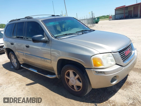 2003 GMC Envoy SLT with VIN 1GKDS13S732150215, listed as a IAAI auction lot 42048209 with 329,719 mi miles. Bid and sale history available at carsss.com. Image 1.