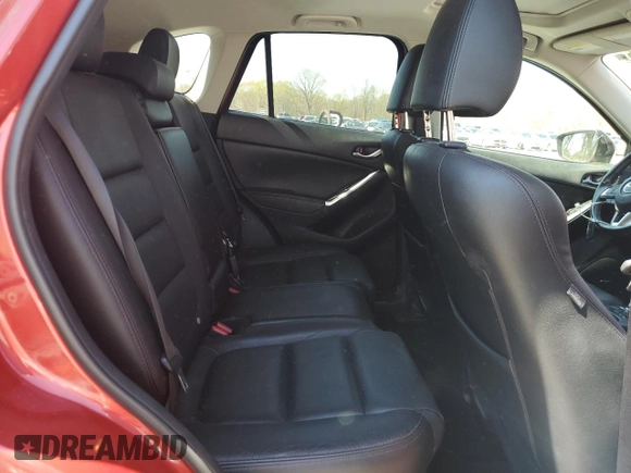 2016 Mazda CX-5 Grand Touring z VIN JM3KE2DYXG0840777, wystawiony jako Copart lot #49700585 z przebiegiem 116 469 mil mil oraz Szkoda całkowita • Salvage title. Historia ofert i sprzedaży dostępna na DreamBid. Obrazek 11.