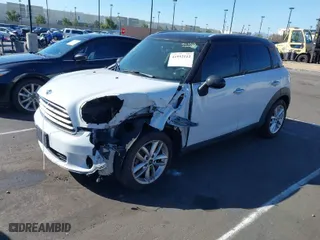 2014 MINI Cooper Countryman with VIN WMWZB3C53EWR39767, listed as a IAAI auction lot 41592112 with 129,403 mi miles. Bid and sale history available at carsss.com. Image 2.
