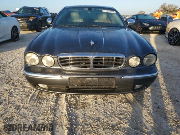 2004 Jaguar XJ with VIN SAJEA74C24SG09038, listed as a Copart auction lot 77015544 with Not Provided miles and Salvage Title. Bid and sale history available at DreamBid. Image 5.