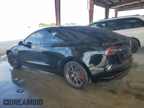 2021 Tesla Model 3 Standard Range Plus with VIN 5YJ3E1EA2MF048564, listed as a Copart auction lot 88754285 with 57,894 mi miles and Non Repairable. Bid and sale history available at DreamBid. Image 2.