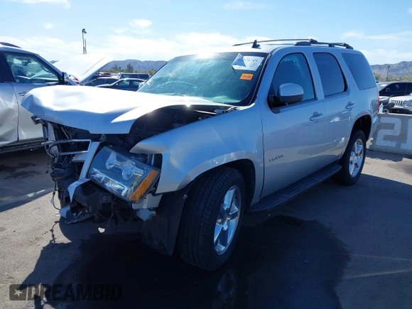 2013 Chevrolet Tahoe LT with VIN 1GNSKBE01DR157083, listed as a IAAI auction lot 41759189 with 153,403 mi miles and . Bid and sale history available at DreamBid. Image 2.
