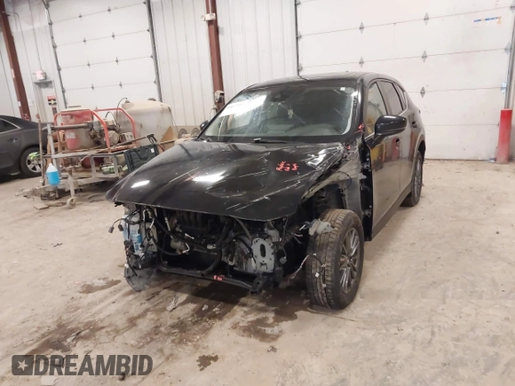 2021 Mazda CX-5 Touring with VIN JM3KFBCM1M1380409, listed as a IAAI auction lot 41677537 with 55,319 mi miles. Bid and sale history available at carsss.com. Image 6.