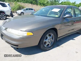 1999 Oldsmobile Intrigue GX z VIN 1G3WH52K5XF334949, wystawiony jako IAAI lot #42252647 z przebiegiem 80 705 mil mil oraz . Historia ofert i sprzedaży dostępna na DreamBid. Obrazek 6.