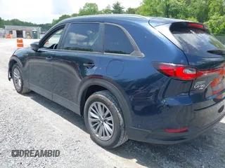 2024 Mazda CX-90 Select z VIN JM3KKAHD4R1142933, wystawiony jako IAAI lot #42269979 z przebiegiem 30 373 mil mil oraz . Historia ofert i sprzedaży dostępna na DreamBid. Obrazek 3.