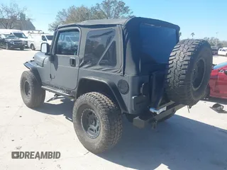 2003 Jeep Wrangler X with VIN 1J4FA39S03P314685, listed as a IAAI auction lot 41649741 with 119,924 mi miles. Bid and sale history available at carsss.com. Image 3.