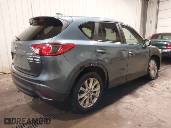 2015 Mazda CX-5 Grand Touring with VIN JM3KE4DY7F0504398, listed as a IAAI auction lot 41698365 with 122,121 mi miles. Bid and sale history available at carsss.com. Image 4.