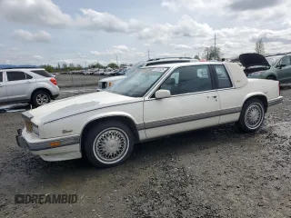 1991 Cadillac Eldorado z VIN 1G6EL13B9MU604115, wystawiony jako Copart lot #52232425 z przebiegiem 95 570 mil mil oraz Szkody całkowita. Historia ofert i sprzedaży dostępna na DreamBid. Obrazek 1.