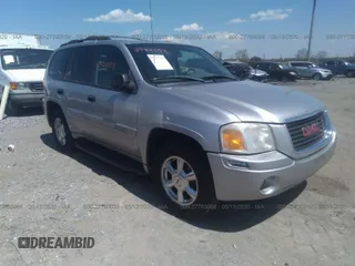 2004 GMC Envoy SLE with VIN 1GKDT13S142376233, listed as a IAAI auction lot 27700058 with 184,909 mi miles. Bid and sale history available at carsss.com. Image 1.