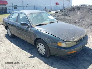 1995 Toyota Camry LE z VIN 4T1SK12E3SU576500, wystawiony jako IAAI lot #42186816 z przebiegiem 216 809 mil mil oraz . Historia ofert i sprzedaży dostępna na DreamBid. Obrazek 1.