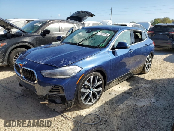 2021 BMW X2 sDrive28i with VIN WBXYH9C02M5S54591, listed as a Copart auction lot 77223834 with 0 mi miles and Salvage Title. Bid and sale history available at carsss.com. Image 1.