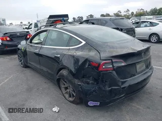 2019 Tesla Model 3 Mid Range with VIN 5YJ3E1EA2KF362048, listed as a IAAI auction lot 40141734 with 70,321 mi miles and . Bid and sale history available at carsss.com. Image 3.