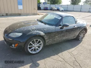 2012 Mazda MX-5 Miata Grand Touring z VIN JM1NC2PF5C0222556, wystawiony jako Copart lot #57149045 z przebiegiem 166 781 mil mil oraz Szkoda całkowita • Salvage title. Historia ofert i sprzedaży dostępna na DreamBid. Obrazek 1.