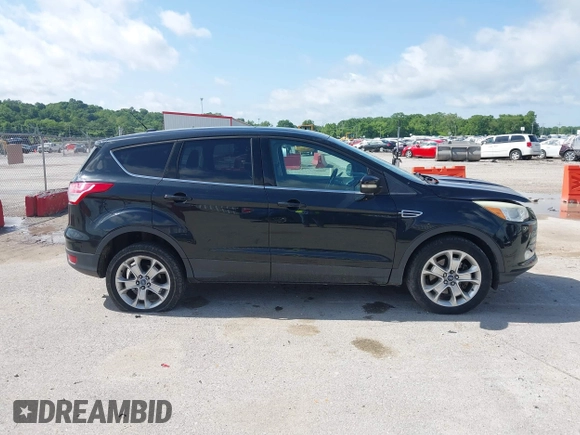 2013 Ford Escape SEL with VIN 1FMCU9HX1DUB97939, listed as a IAAI auction lot 42293561 with 196,951 mi miles and . Bid and sale history available at DreamBid. Image 14.