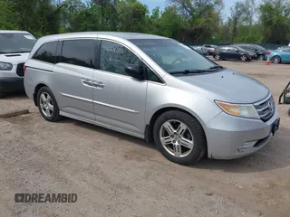 2012 Honda Odyssey Touring with VIN 5FNRL5H92CB055473, listed as a IAAI auction lot 42128601 with 163,901 mi miles. Bid and sale history available at carsss.com. Image 1.