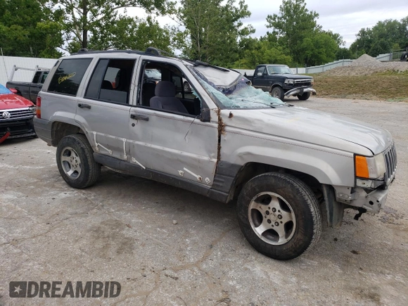 1996 Jeep Grand Cherokee Laredo with VIN 1J4GZ58S2TC401845, listed as a Copart auction lot 61013044 with 0 mi miles and Salvage Title. Bid and sale history available at carsss.com. Image 4.