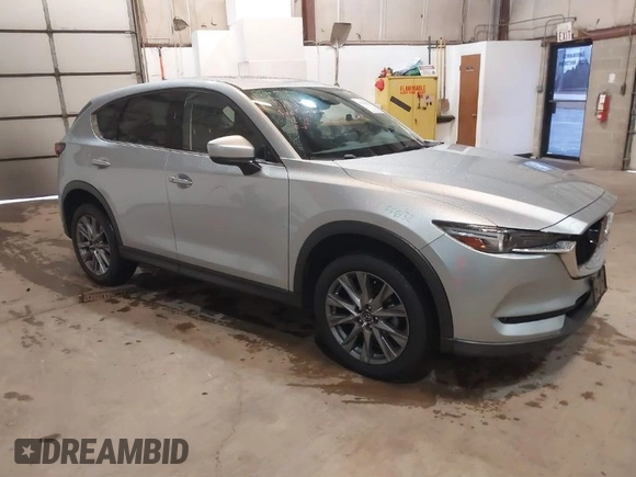 2021 Mazda CX-5 Grand Touring with VIN JM3KFADMXM1318015, listed as a IAAI auction lot 41221528 with 79,473 mi miles. Bid and sale history available at carsss.com. Image 1.