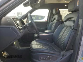 2023 Rivian R1T Adventure with VIN 7FCTGAAA2PN017170, listed as a Copart auction lot 77473014 with 28,821 mi miles and Salvage Title. Bid and sale history available at DreamBid. Image 7.