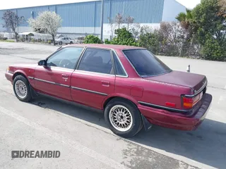 1991 Toyota Camry z VIN JT2SV21E0M3462782, wystawiony jako IAAI lot #41841451 z przebiegiem 214 611 mil mil oraz . Historia ofert i sprzedaży dostępna na DreamBid. Obrazek 3.