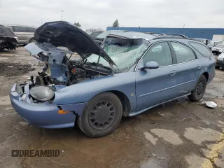 1999 Ford Taurus SE z VIN 1FAFP58SXXG258283, wystawiony jako Copart lot #85334734 z przebiegiem 156 705 mil mil oraz Tytuł czysty. Historia ofert i sprzedaży dostępna na DreamBid. Obrazek 1.