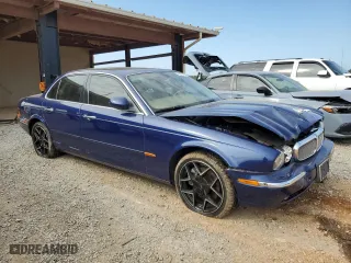 2004 Jaguar XJ with VIN SAJWA71C34SG19800, listed as a Copart auction lot 71877194 with 157,051 mi miles and Salvage Title. Bid and sale history available at carsss.com. Image 4.