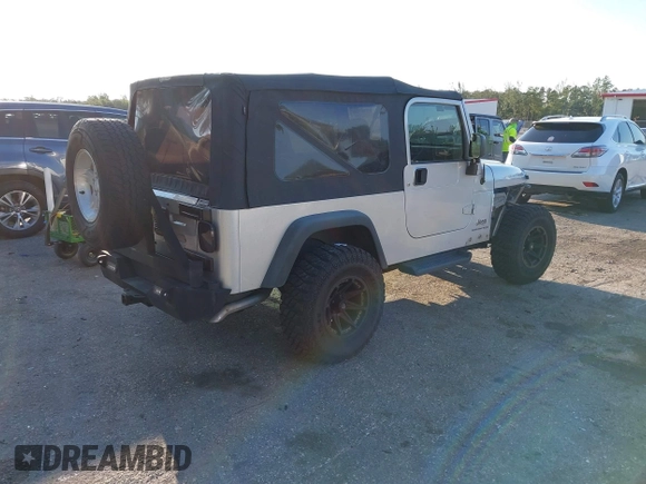 2005 Jeep Wrangler Unlimited with VIN 1J4FA44S65P335444, listed as a IAAI auction lot 41731093 with 143,918 mi miles. Bid and sale history available at carsss.com. Image 4.