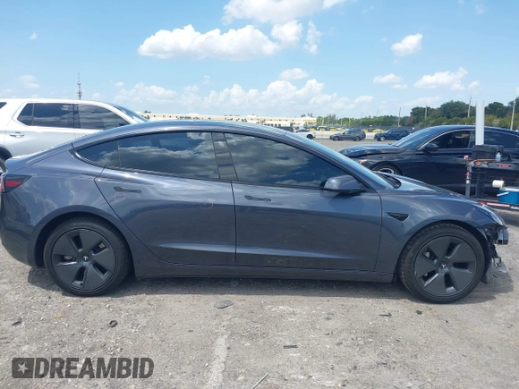 2023 Tesla Model 3 with VIN 5YJ3E1EAXPF575448, listed as a IAAI auction lot 42019288 with 33,859 mi miles and . Bid and sale history available at carsss.com. Image 14.