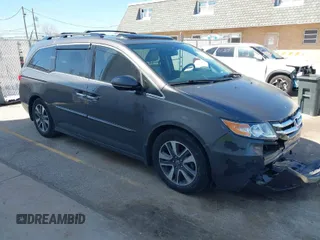 2014 Honda Odyssey Touring with VIN 5FNRL5H97EB101169, listed as a IAAI auction lot 41869233 with 142,147 mi miles and . Bid and sale history available at carsss.com. Image 1.