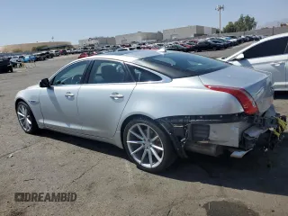 2015 Jaguar XJ with VIN SAJWJ1CD4F8V82496, listed as a Copart auction lot 71013474 with 52,744 mi miles and Salvage title. Bid and sale history available at DreamBid. Image 2.