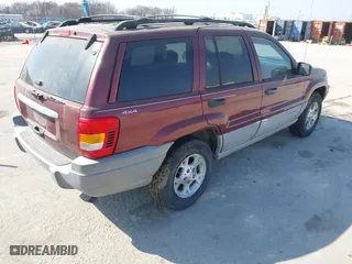 1999 Jeep Grand Cherokee Laredo with VIN 1J4GW58S6XC554582, listed as a IAAI auction lot 41780284 with 183,156 mi miles. Bid and sale history available at carsss.com. Image 4.