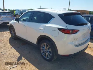 2021 Mazda CX-5 Grand Touring with VIN JM3KFBDM3M0493752, listed as a IAAI auction lot 42456854 with 35,122 mi miles and . Bid and sale history available at DreamBid. Image 3.